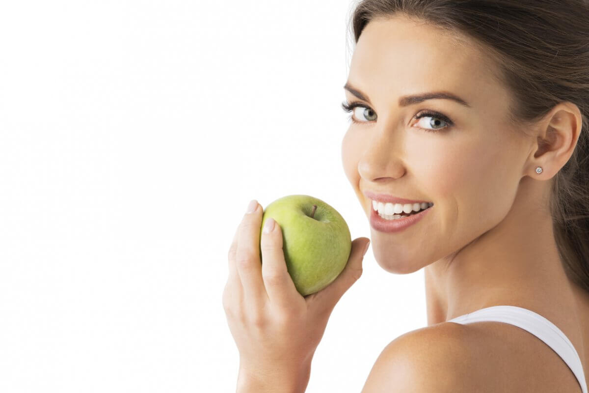 woman with beautiful smiling holding apple