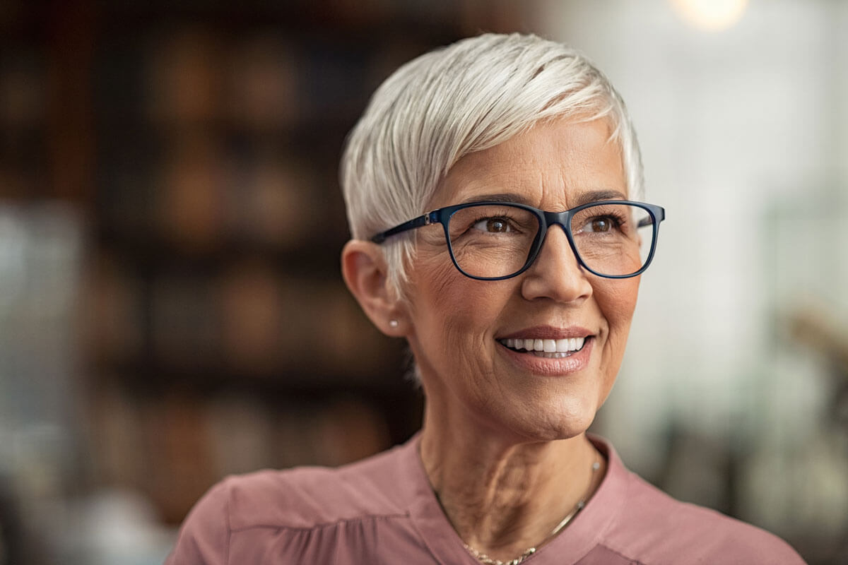 mature woman smiles with dental implants