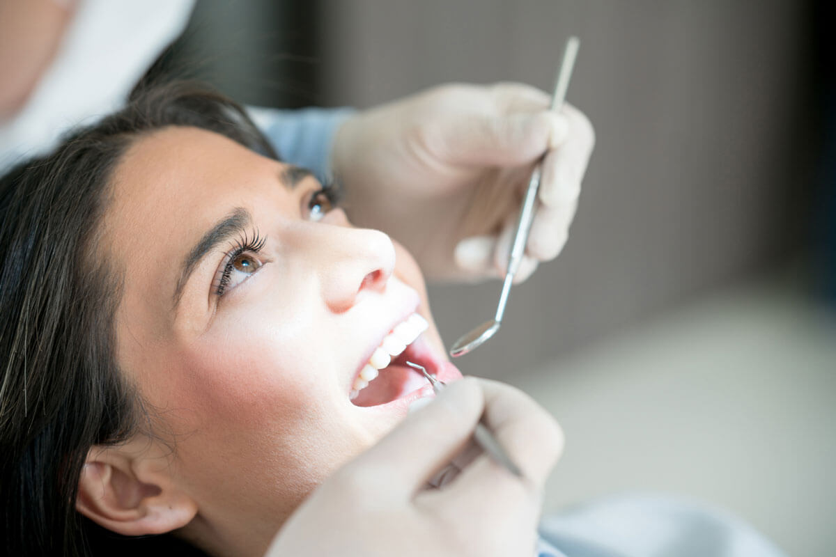 woman smiles in dental chair